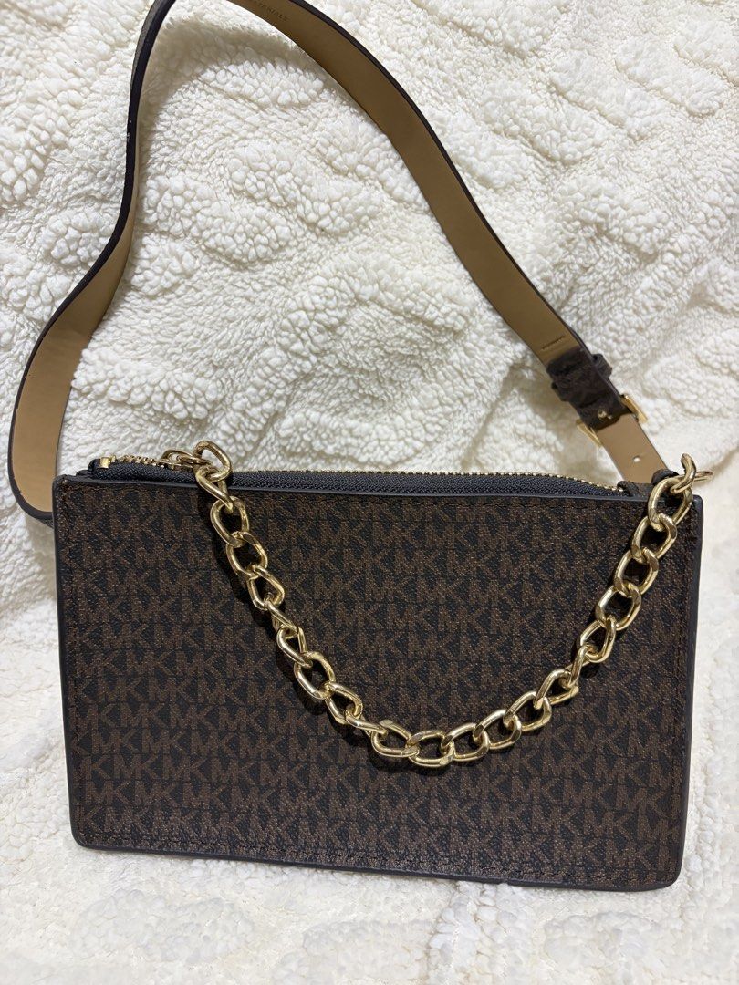 Michael Kors Brown MK Monogram Crossbody Bag (Category: Luxury Bags & Wallets) located in Paranaque City. Submitted by greatfinds108 (Listing ID 1466822442, Image 1). Description: Michael Kors crossbody bag in brown monogram print. Chunky gold chain detail on the front. Zip top closure keeps things secure. Tan adjustable strap included. Slim profile, easy to carry around. Clean interior lining with zipper opening. For pick up only.