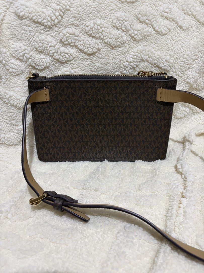 Michael Kors Brown MK Monogram Crossbody Bag (Category: Luxury Bags & Wallets) located in Paranaque City. Submitted by greatfinds108 (Listing ID 1466822442, Image 2). Description: Michael Kors crossbody bag in brown monogram print. Chunky gold chain detail on the front. Zip top closure keeps things secure. Tan adjustable strap included. Slim profile, easy to carry around. Clean interior lining with zipper opening. For pick up only.