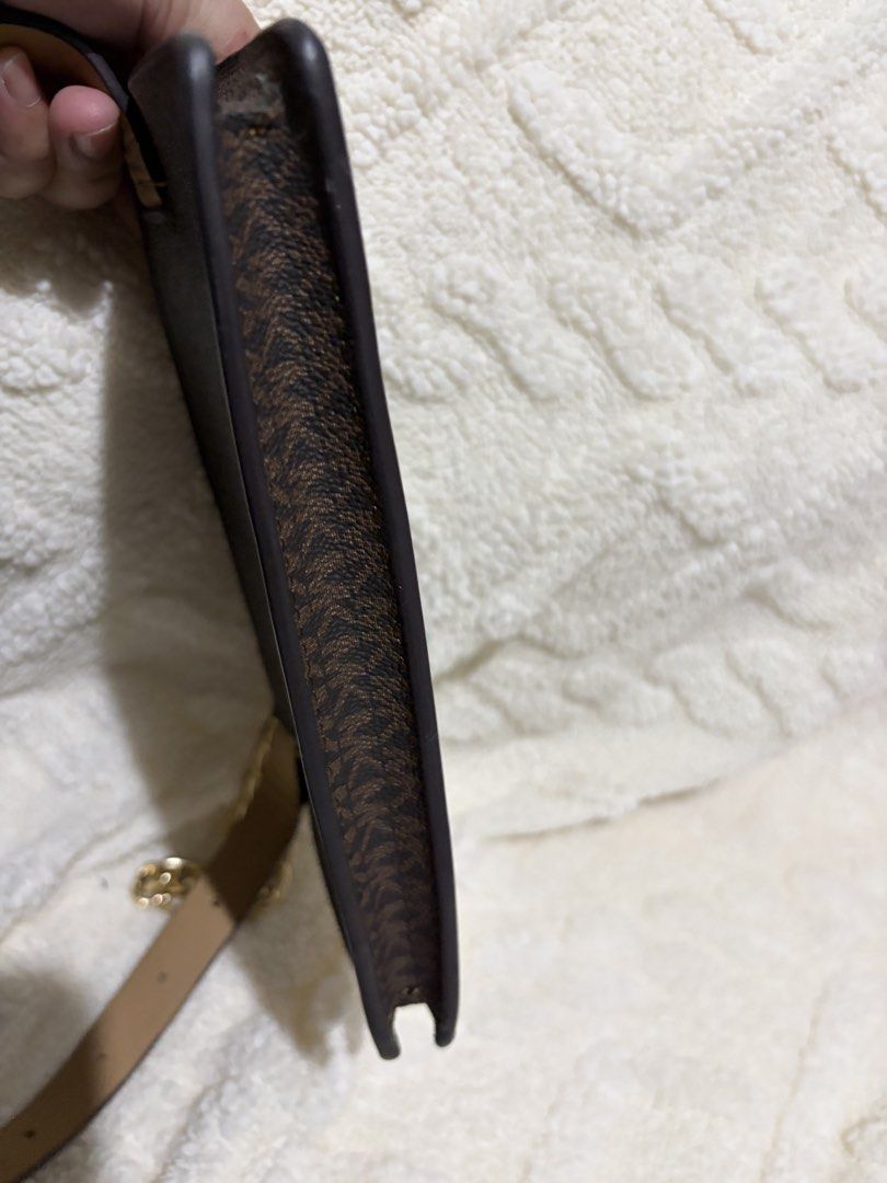 Michael Kors Brown MK Monogram Crossbody Bag (Category: Luxury Bags & Wallets) located in Paranaque City. Submitted by greatfinds108 (Listing ID 1466822442, Image 3). Description: Michael Kors crossbody bag in brown monogram print. Chunky gold chain detail on the front. Zip top closure keeps things secure. Tan adjustable strap included. Slim profile, easy to carry around. Clean interior lining with zipper opening. For pick up only.