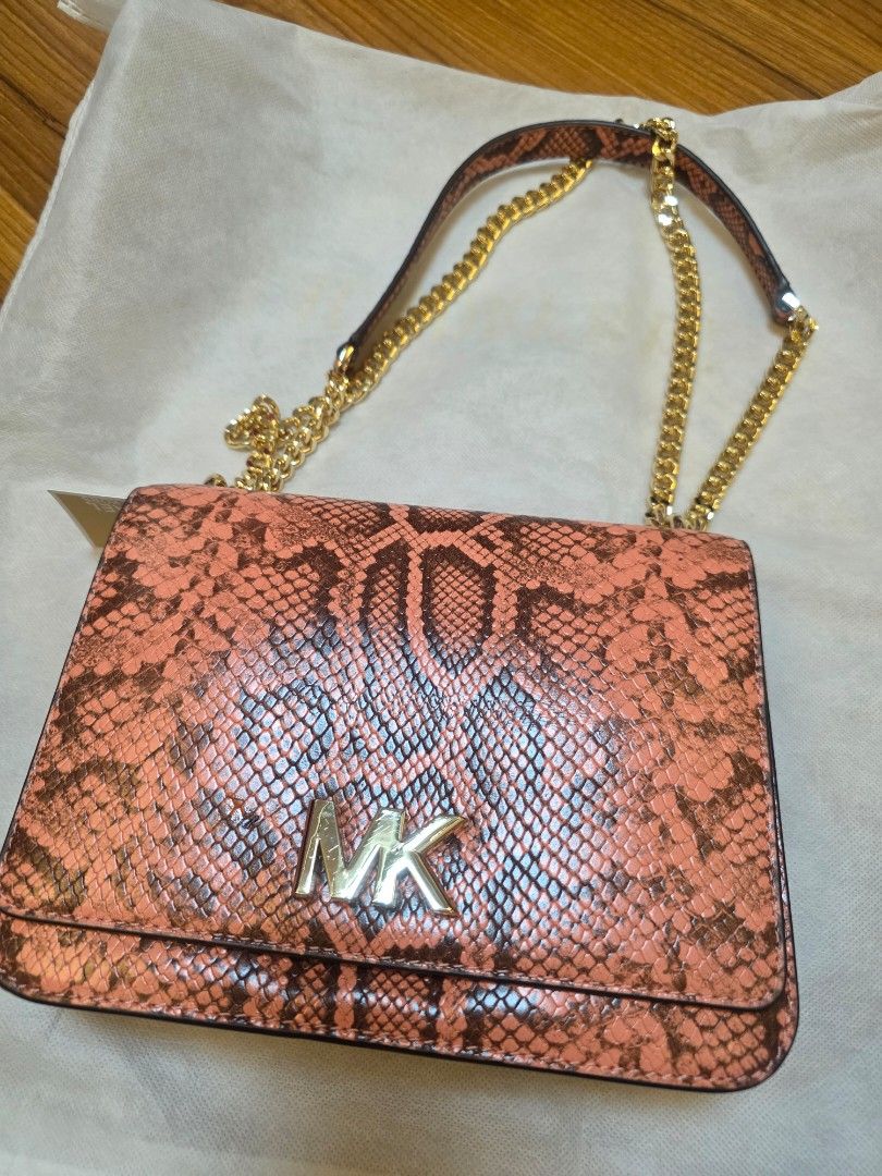 Michael Kors Mott Peach Multi Embossed Leather Shoulder Bag (Category: Shoulder Bags) located in Iligan City. Submitted by ilovechocolatecakes (Listing ID 1466784681, Image 2). Description: - Brand: Michael Kors - Style: Mott Shoulder Bag - Color: Peach Multi with smooth peach leather flap - Material: Snake-embossed and smooth leather - Hardware: Gold-tone hardware and chain strap - Features: Interior zip pocket for organization - Condition: Bran