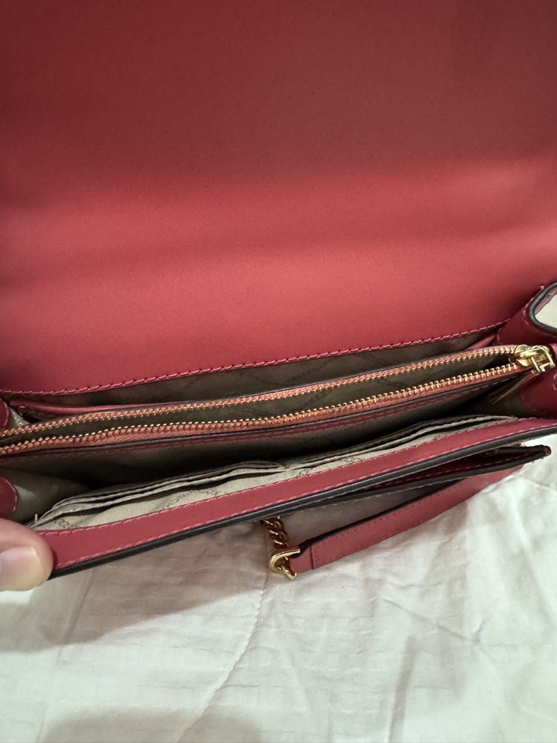 Michael Kors Red Leather Chain Shoulder Bag (Category: Luxury Bags & Wallets) located in Manila. Submitted by herreradav92264 (Listing ID 1466827906, Image 3). Description: - Authentic red leather Michael Kors shoulder bag - Elegant gold-tone hardware and chic chain strap - Front flap with secure magnetic snap closure - Organized interior with multiple compartments, card slots, and zippered pocket - Signature MK logo lining - Convenient exterior 