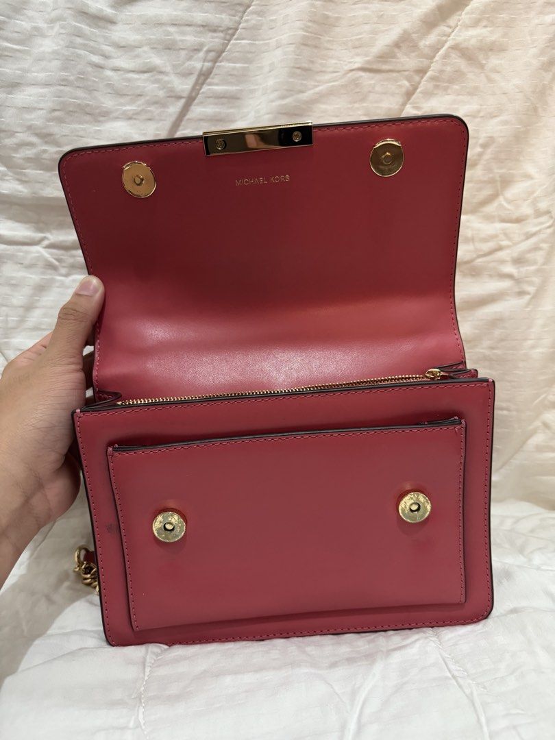 Michael Kors Red Leather Chain Shoulder Bag (Category: Luxury Bags & Wallets) located in Manila. Submitted by herreradav92264 (Listing ID 1466827906, Image 2). Description: - Authentic red leather Michael Kors shoulder bag - Elegant gold-tone hardware and chic chain strap - Front flap with secure magnetic snap closure - Organized interior with multiple compartments, card slots, and zippered pocket - Signature MK logo lining - Convenient exterior 