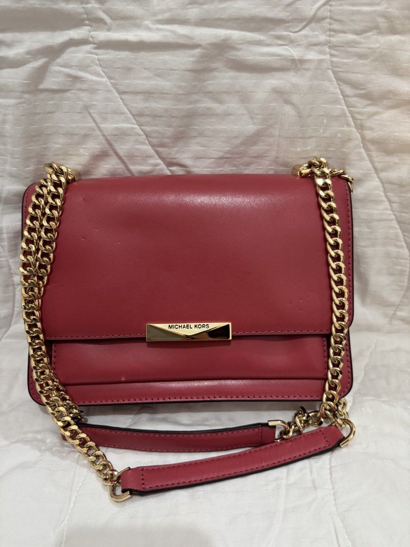 Michael Kors Red Leather Chain Shoulder Bag (Category: Luxury Bags & Wallets) located in Manila. Submitted by herreradav92264 (Listing ID 1466827906, Image 1). Description: - Authentic red leather Michael Kors shoulder bag - Elegant gold-tone hardware and chic chain strap - Front flap with secure magnetic snap closure - Organized interior with multiple compartments, card slots, and zippered pocket - Signature MK logo lining - Convenient exterior 