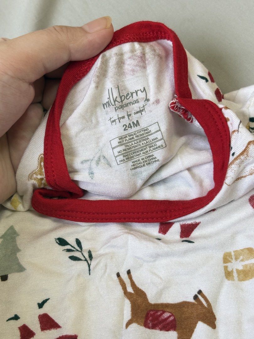 Milkberry Christmas Pyjamas Set 24M (Category: Babies & Kids Fashion) located in Quezon City. Submitted by sailormooooo (Listing ID 1466921036, Image 2). Description: - Brand: Milkberry - Size: 24M (Toddler) - Design: Festive holiday print with Santa, reindeer, snowmen, and Christmas trees - Features: Long sleeves, long pants, contrasting red collar and cuffs, and tag-free comfort - Material: Soft and cozy, ideal for holiday lounging and bedtime.