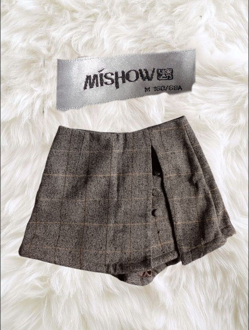Mishow Brown Plaid Skorts Size M (Category: Skirts) located in Abucay. Submitted by lovedby.herrr (Listing ID 1466829689, Image 1). Description: Mishow brown herringbone plaid skorts, Size M (160/68A). Features an asymmetrical front wrap, side button details, and hidden shorts for comfort. Perfect for autumn or casual days out. Excellent, clean condition..