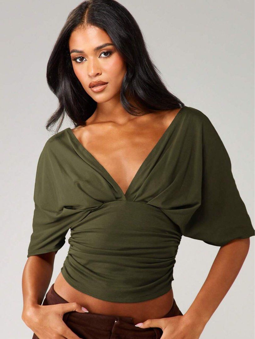 Missguided Olive Green Deep V-Neck Ruched Top (Category: Sleeveless) located in Quezon City. Submitted by getitrightaway.ph (Listing ID 1466846894, Image 1). Description: - Brand: Missguided (Original tag still attached) - Color: Olive green - Neckline: Deep V-neck in front and back - Sleeves: Draped dolman sleeves - Fit: Ruched sides with a fitted waist - Condition: Brand new.