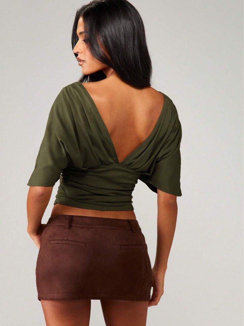 Missguided Olive Green Deep V-Neck Ruched Top (Category: Sleeveless) located in Quezon City. Submitted by getitrightaway.ph (Listing ID 1466846894, Image 3). Description: - Brand: Missguided (Original tag still attached) - Color: Olive green - Neckline: Deep V-neck in front and back - Sleeves: Draped dolman sleeves - Fit: Ruched sides with a fitted waist - Condition: Brand new.