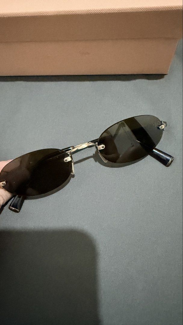 Miu Miu Oval Sunglasses (Selling low) (Category: Sunglasses & Eyewear) located in Manila. Submitted by casayuranhannahmae.1 (Listing ID 1466779234, Image 2). Description: - Original Miu Miu sunglasses - Oval frame design - Silver-tone metal frame - Dark lenses - Includes original case, cleaning cloth, and paperwork - Model number: SMU A54 51D20 26C-09Z 140 3N - Perfect for everyday wear - with box and case - RFS: Never worn.