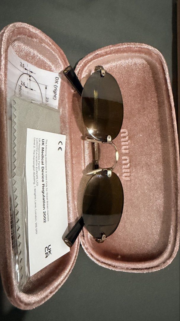 Miu Miu Oval Sunglasses (Selling low) (Category: Sunglasses & Eyewear) located in Manila. Submitted by casayuranhannahmae.1 (Listing ID 1466779234, Image 3). Description: - Original Miu Miu sunglasses - Oval frame design - Silver-tone metal frame - Dark lenses - Includes original case, cleaning cloth, and paperwork - Model number: SMU A54 51D20 26C-09Z 140 3N - Perfect for everyday wear - with box and case - RFS: Never worn.