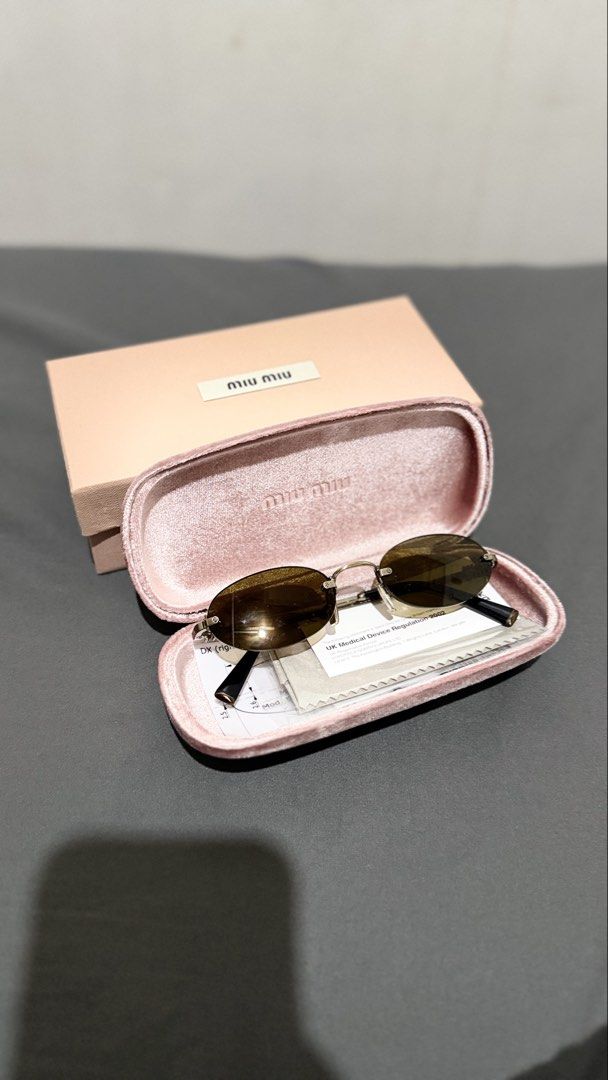 Miu Miu Oval Sunglasses (Selling low) (Category: Sunglasses & Eyewear) located in Manila. Submitted by casayuranhannahmae.1 (Listing ID 1466779234, Image 1). Description: - Original Miu Miu sunglasses - Oval frame design - Silver-tone metal frame - Dark lenses - Includes original case, cleaning cloth, and paperwork - Model number: SMU A54 51D20 26C-09Z 140 3N - Perfect for everyday wear - with box and case - RFS: Never worn.