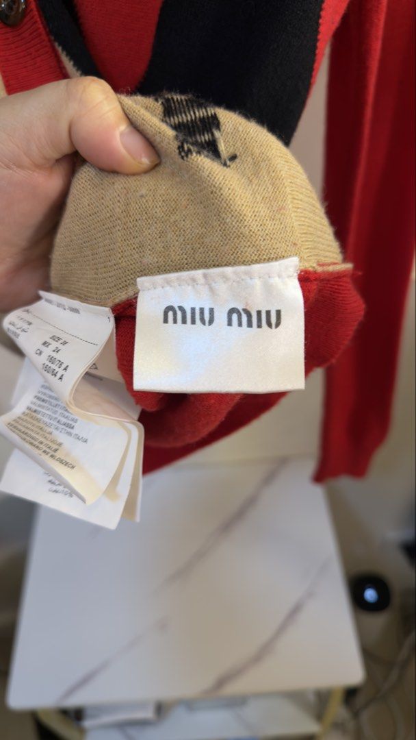 Miu Miu Red Black Beige Pattern Cardigan Size 38 (Category: Coats, Jackets and Outerwear) located in Paranaque City. Submitted by preluxeshop_ph (Listing ID 1466962992, Image 3). Description: Miu Miu Red Black Beige Pattern Cardigan Size 38 -V-neck front with button closure -Embroidered branding near the bottom hem. Size 38 listed on the inner tag -Made in Italy.