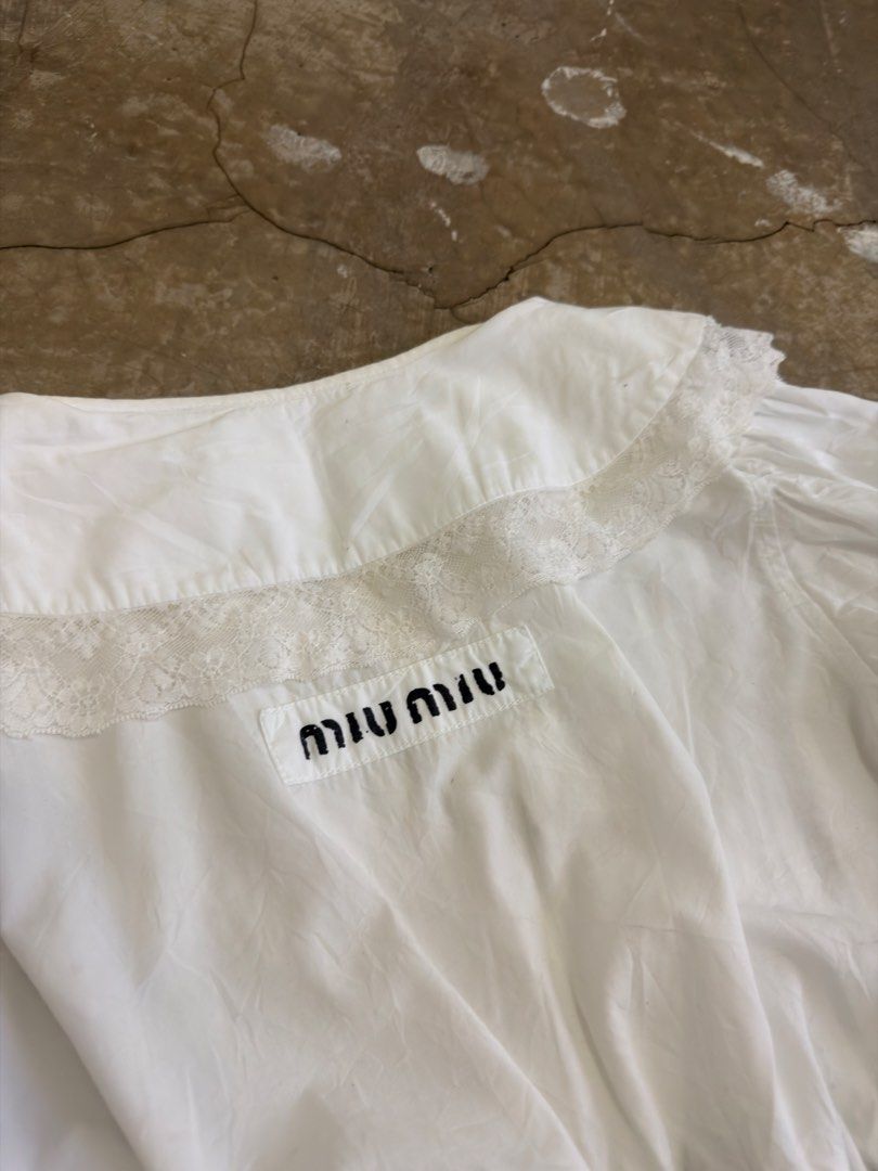 Miu Miu White Cotton Lace top (Category: Luxury Apparel) located in Alfonso. Submitted by jbcamet (Listing ID 1466879744, Image 3). Description: - Brand: Miu Miu - Origin: Made in Italy - Size: 36 - Material: 100% Cotton - Details: Delicate lace paneling with elasticated gathering - Care: Cold hand wash inside out - Authenticity: Includes official tag with QR code and NFC chip (RN 98339, CA 34767).