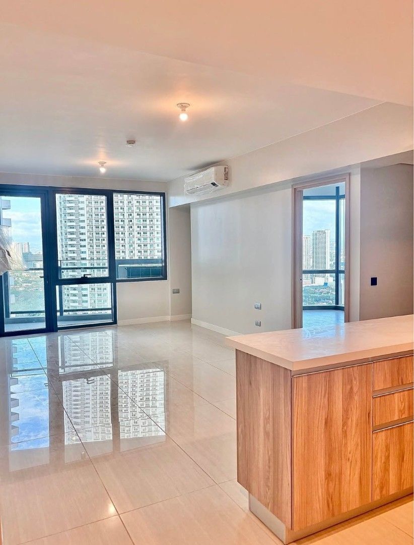 Modern Condominium Unit With City View And Kitchen (Category: Apartments & Condos) located in Manila. Submitted by raymark24 (Listing ID 1466893209, Image 1). Description: EARLY MOVE IN PROMO 1BR 65SQM EMPRESS AT CAPITOL COMMONS 1BR UNIT WITH PARKING LOT - Spacious modern condo unit with abundant natural light - Floor-to-ceiling glass windows offering a stunning city skyline view - Open-concept kitchen equipped with wooden cabinetry and breakfast