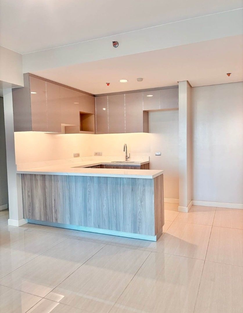 Modern Condominium Unit With City View And Kitchen (Category: Apartments & Condos) located in Manila. Submitted by raymark24 (Listing ID 1466893209, Image 2). Description: EARLY MOVE IN PROMO 1BR 65SQM EMPRESS AT CAPITOL COMMONS 1BR UNIT WITH PARKING LOT - Spacious modern condo unit with abundant natural light - Floor-to-ceiling glass windows offering a stunning city skyline view - Open-concept kitchen equipped with wooden cabinetry and breakfast