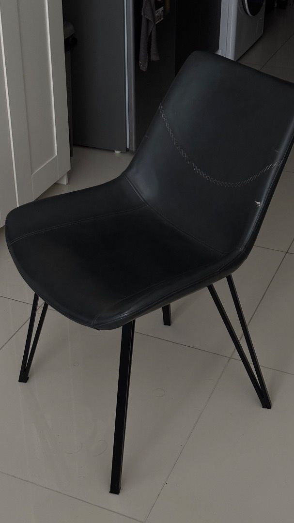 Modern Leather Chair (Category: Chairs) located in Manila. Submitted by cmjuyad (Listing ID 1466857281, Image 1). Description: - Color: Sleek black - Material: Premium faux leather with a sturdy steel frame and black metal legs - Design: Curved backrest featuring stylish decorative stitching - Perfect for: Upgrading your dining space or home office on a budget - Issue: Small streak/damage on front (as seen in image).