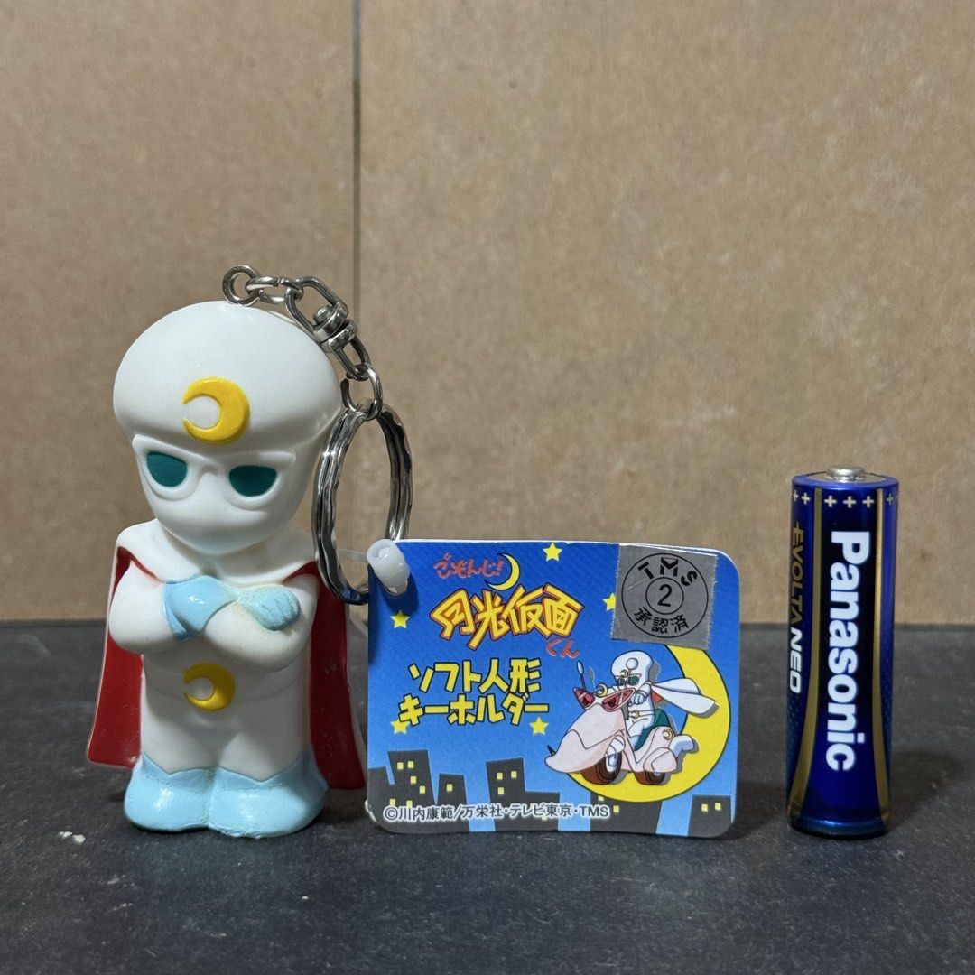 Moonlight Mask Soft Figure Keychain (Category: Character Goods) located in Cuyapo. Submitted by blacksheepshop (Listing ID 1466787498, Image 1). Description: - Item: Moonlight Mask soft figure keychain - Condition: Brand new with original tag and TMS approval sticker - Design: Classic white suit, red cape, blue boots, and yellow crescent moon symbols - Size: Roughly taller than an AA battery - Authenticity: Copyright text stamped on the back of t