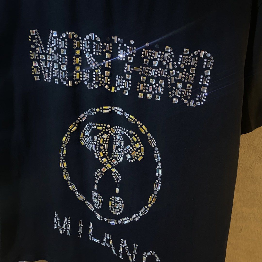 Moschino Jewels Shirt (Category: Luxury Apparel) located in Baguio. Submitted by goodfinds2600v2 (Listing ID 1466891735, Image 2). Description: Size on tag: M fits M-L Dimensions: L-28.5 W/Bust-20 Description: unisex Condition: Very good Issue/s: missing some jewels.