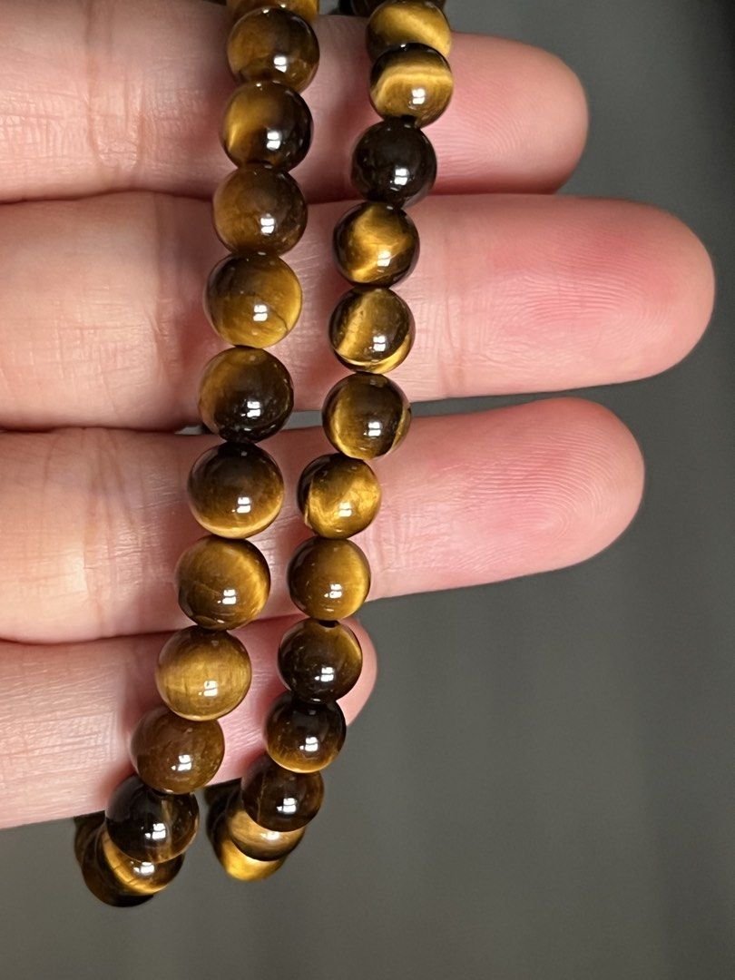 Natural Tiger Eye Gemstone Beaded Bracelet (Category: Bracelets) located in Quezon City. Submitted by ohmystones_088 (Listing ID 1466789759, Image 3). Description: - Material: Natural tiger eye beads with stunning gold and dark brown chatoyant shimmer - Fit: Stretchy cord design, measures approx. 17cm around - Comfort: Smooth, polished round beads ideal for everyday wear - Condition: Clean, well-maintained, and ready to ship 100% Authentic / Natu