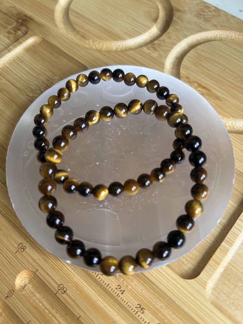 Natural Tiger Eye Gemstone Beaded Bracelet (Category: Bracelets) located in Quezon City. Submitted by ohmystones_088 (Listing ID 1466789759, Image 2). Description: - Material: Natural tiger eye beads with stunning gold and dark brown chatoyant shimmer - Fit: Stretchy cord design, measures approx. 17cm around - Comfort: Smooth, polished round beads ideal for everyday wear - Condition: Clean, well-maintained, and ready to ship 100% Authentic / Natu