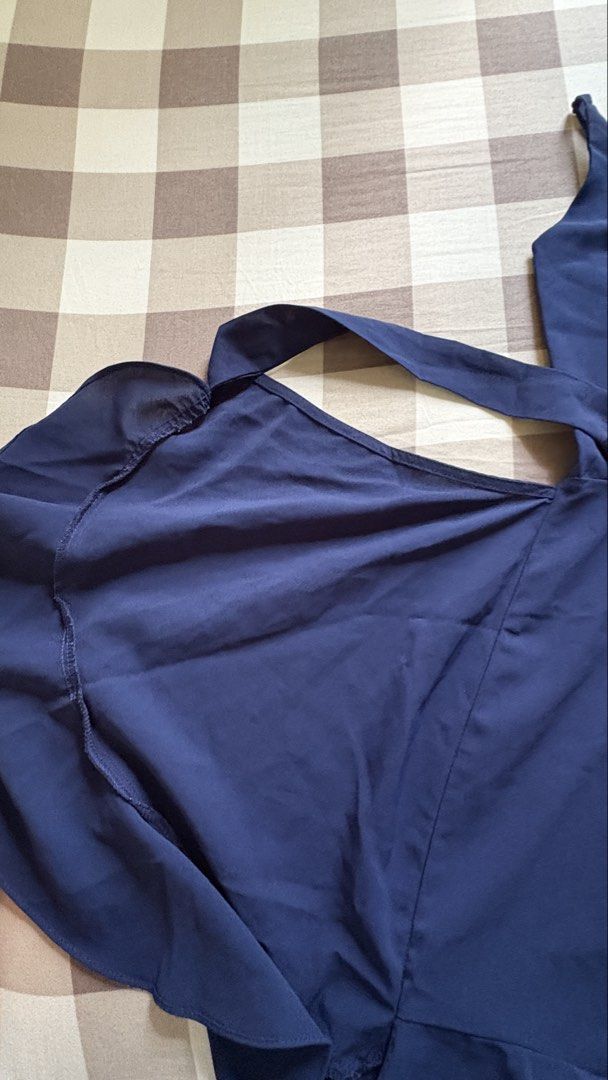 Navy Blue Cami Wrap Dress with Ruffle Hem (Category: Dresses) located in Apalit. Submitted by icekimix (Listing ID 1466866903, Image 3). Description: - Color: Navy blue - Style: Mini dress with a wrap-front and side tie ribbon - Details: Square neckline, adjustable spaghetti straps, and ruffle hem - Fit & Comfort: Lightweight, flowy fabric with subtle back smocking and back zip closure - Fits small - medium.