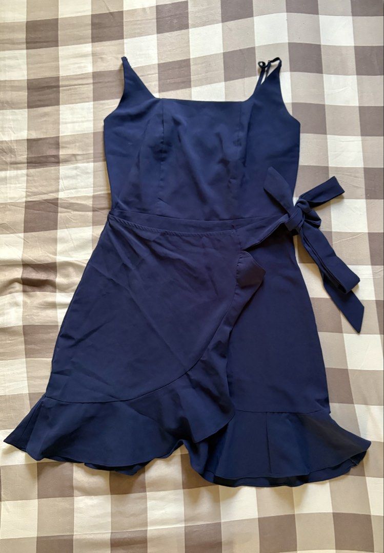 Navy Blue Cami Wrap Dress with Ruffle Hem (Category: Dresses) located in Apalit. Submitted by icekimix (Listing ID 1466866903, Image 1). Description: - Color: Navy blue - Style: Mini dress with a wrap-front and side tie ribbon - Details: Square neckline, adjustable spaghetti straps, and ruffle hem - Fit & Comfort: Lightweight, flowy fabric with subtle back smocking and back zip closure - Fits small - medium.