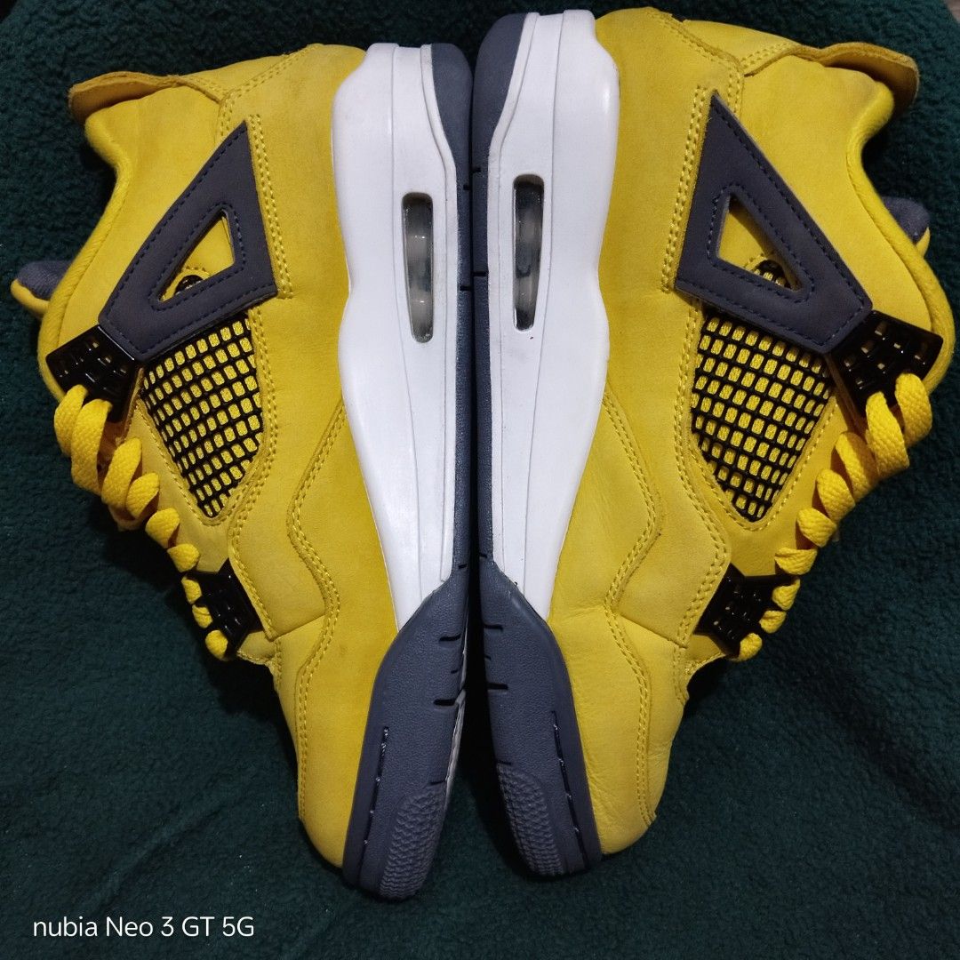 Nike Air Jordan 4 Retro Lightning Yellow (Category: Sneakers) located in Taguig. Submitted by ryanflorenosos (Listing ID 1466899806, Image 2). Description: ** PRICE NEGOTIABLE *** - Brand: Air Jordan 4 Retro - Colorway: Bright yellow with black and grey accents - Details: Signature side panel and tongue mesh netting, matching yellow laces, and iconic Jumpman logo on the tongue and rubber outsole - Condition: Pre-loved with minor dirt on the soles