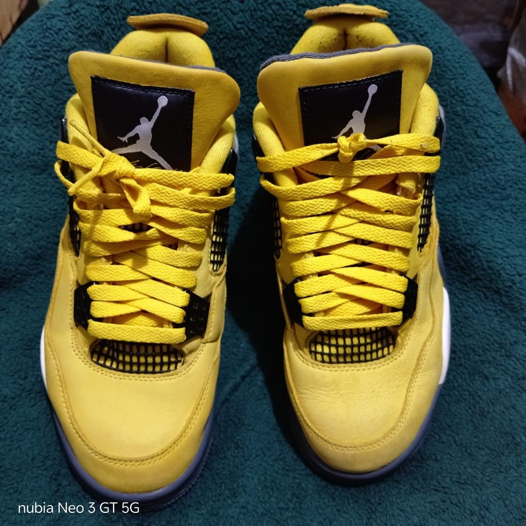 Nike Air Jordan 4 Retro Lightning Yellow (Category: Sneakers) located in Taguig. Submitted by ryanflorenosos (Listing ID 1466899806, Image 3). Description: ** PRICE NEGOTIABLE *** - Brand: Air Jordan 4 Retro - Colorway: Bright yellow with black and grey accents - Details: Signature side panel and tongue mesh netting, matching yellow laces, and iconic Jumpman logo on the tongue and rubber outsole - Condition: Pre-loved with minor dirt on the soles