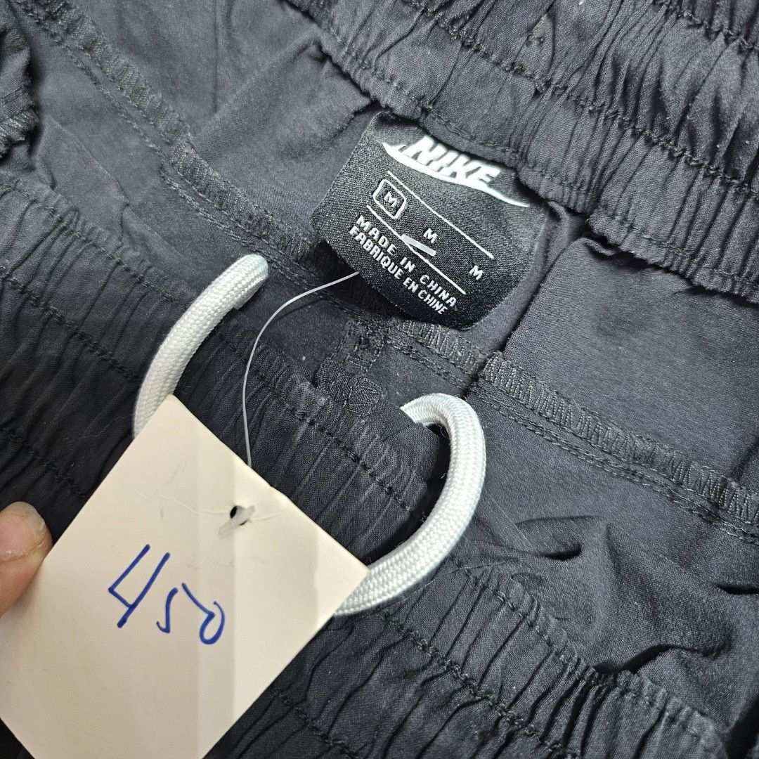 Nike black Shorts (Category: Shorts) located in Baguio. Submitted by kayeonlineshop (Listing ID 1466876560, Image 2). Description: black Nike Sportswear Modern Essentials Unlined Woven Shorts (style code CZ9839-010) featuring a zippered cargo pocket on the right leg and the Nike logo on the left leg w26-38l17.5h12.