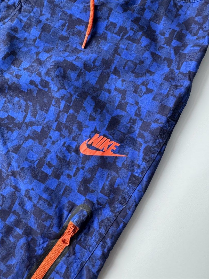 Nike Blue Pixel Pattern Swim Board Shorts Size 32 M (Category: Swim Trunks & Board Shorts) located in Cavite. Submitted by dracokidstuff (Listing ID 1466874404, Image 3). Description: Nike board shorts in blue with a pixelated all-over pattern. Bright orange drawstring waist and matching orange Nike logo on the left leg. Includes a zippered pocket on the left thigh with an orange zipper pull. Made of 100 percent polyester. Tag size 32, medium. Ma
