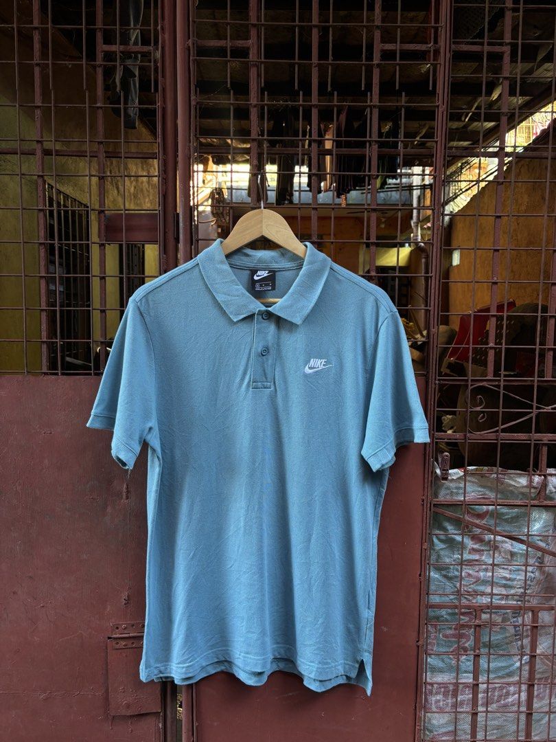 Nike Blue Polo Shirt Size M (Category: Tshirts & Polo Shirts ) located in Manila. Submitted by thriftkibs (Listing ID 1466775724, Image 1). Description: - Brand: Nike - Size: Men's Medium - Color: Blue - Material: Classic pique cotton - Details: Button placket, standard collar, clean neckline, small embroidered white Nike logo on chest - Style Code: CJ4457-424 - Origin: Made in Vietnam.