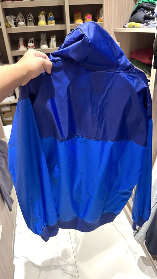 Nike Blue Windbreaker Jacket Size M (Category: Coats, Jackets and Outerwear) located in Quezon City. Submitted by helloimcharles (Listing ID 1466965587, Image 2). Description: - Size: Medium - Design: Colorblock with hood, adjustable white drawstrings, full zip closure, and embroidered white Nike logo - Features: Elastic cuffs and hem, lightweight material - Ideal for: Workouts or breezy days.