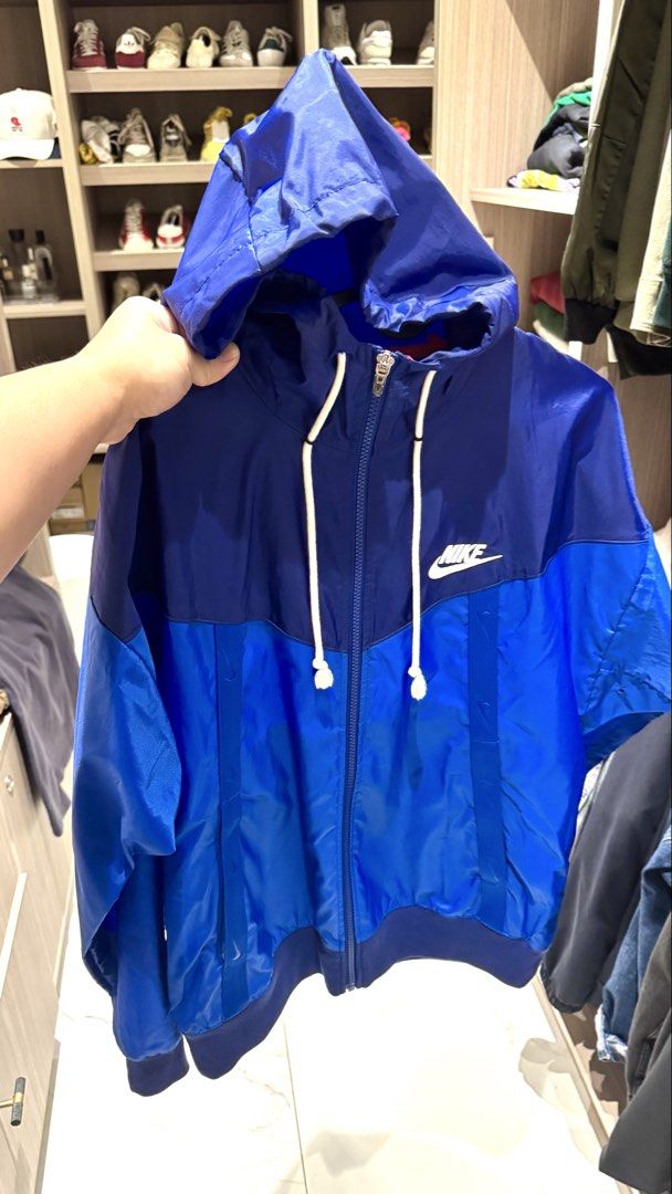 Nike Blue Windbreaker Jacket Size M (Category: Coats, Jackets and Outerwear) located in Quezon City. Submitted by helloimcharles (Listing ID 1466965587, Image 1). Description: - Size: Medium - Design: Colorblock with hood, adjustable white drawstrings, full zip closure, and embroidered white Nike logo - Features: Elastic cuffs and hem, lightweight material - Ideal for: Workouts or breezy days.