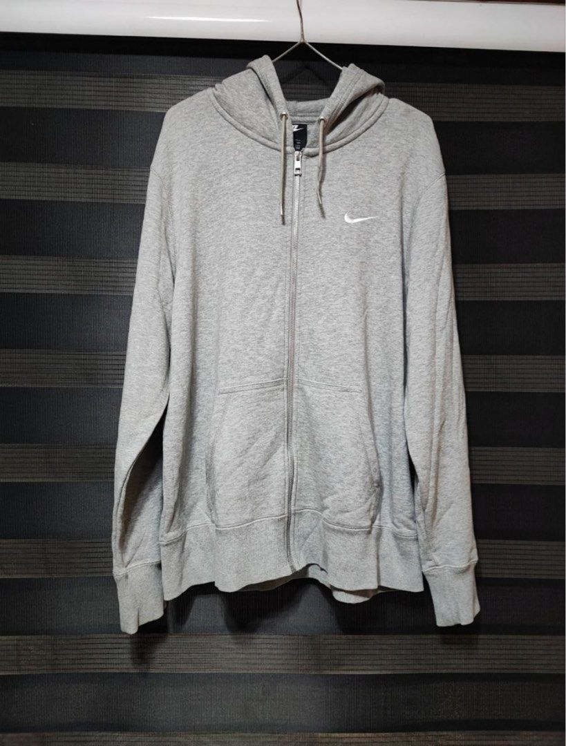 Nike Gray Full Zip Hoodie (Category: Hoodies) located in Pasig City. Submitted by abogadosupremo (Listing ID 1466961116, Image 2). Description: - Color: Gray with white embroidered Nike swoosh on the chest - Closure: Full-zip design with adjustable drawstring hood - Pockets: Two convenient front pockets - Material: Soft and comfortable cotton blend - Fit: Standard fit, ideal for everyday casual wear - THIS IS LEGIT AND ORIGINAL - VERY GOOD CONDIT