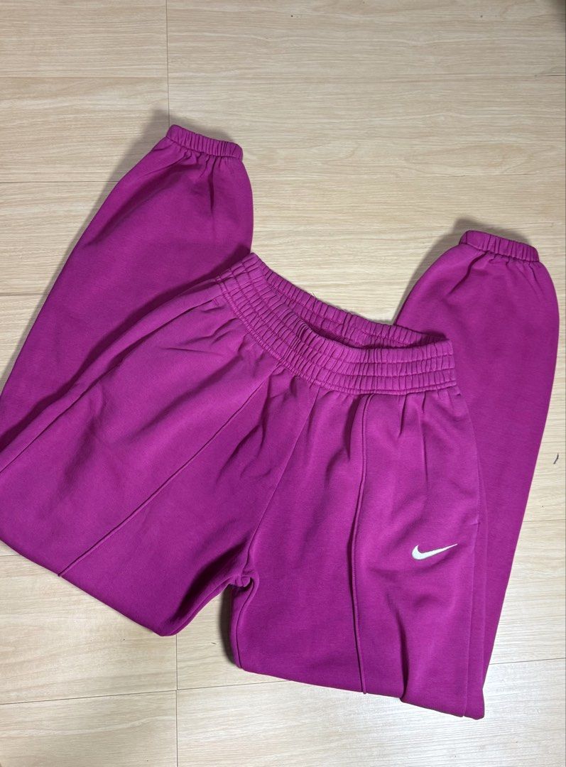 Nike Pink Sweatpants Joggers Size XS (Category: Joggers) located in Baguio. Submitted by zeemoda01 (Listing ID 1466932437, Image 2). Description: Waistline 24-32 - Brand: Nike - Color: Bright pink with white embroidered swoosh - Size: Extra Small (XS) - tag attached - Material & Feel: Super soft fleece lining inside, clean fabric all around - Design: Elastic waistband, ribbed ankle cuffs, and chic front center creases on both legs.