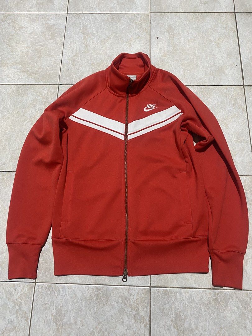 Nike Red Track Jacket (Category: Coats, Jackets and Outerwear) located in Manila. Submitted by wheeze_2208 (Listing ID 1466793424, Image 1). Description: Selling this Nike red track jacket with a white chevron design. Classic sporty look, full zipper, and front pockets. Perfect for casual outfits, streetwear, and everyday use. - Brand: Nike - Color: Red and White - Style: Track Jacket - Condition: Please see photos for actual condition. - Minor i