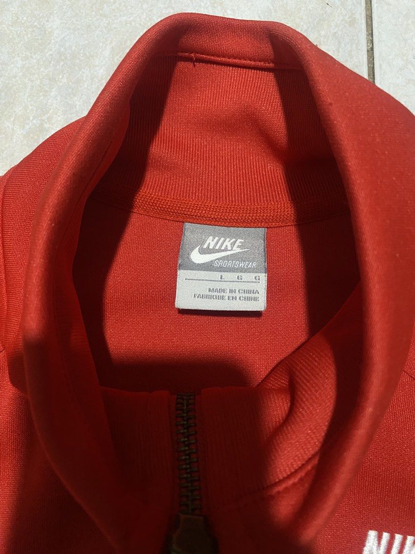 Nike Red Track Jacket (Category: Coats, Jackets and Outerwear) located in Manila. Submitted by wheeze_2208 (Listing ID 1466793424, Image 2). Description: Selling this Nike red track jacket with a white chevron design. Classic sporty look, full zipper, and front pockets. Perfect for casual outfits, streetwear, and everyday use. - Brand: Nike - Color: Red and White - Style: Track Jacket - Condition: Please see photos for actual condition. - Minor i
