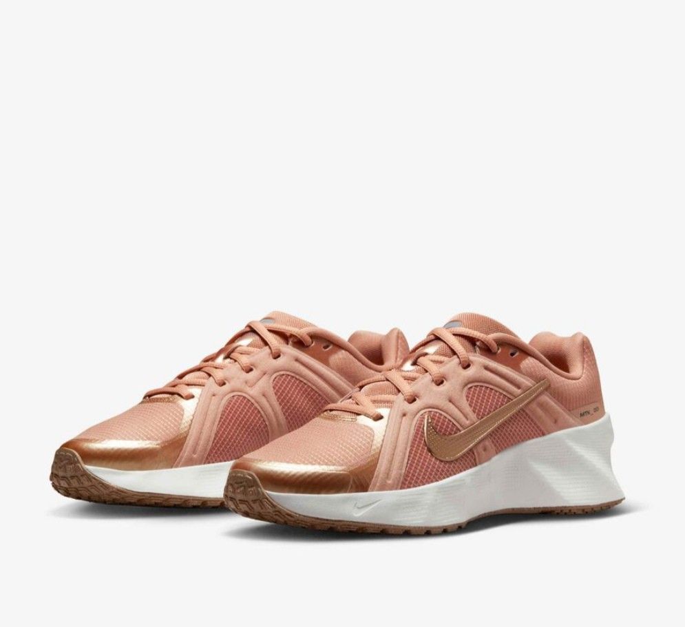 Nike Rose Gold Athletic Sneakers (Category: Sneakers) located in San Jose del Monte. Submitted by Skin_Care2022 (Listing ID 1466798700, Image 2). Description: - Brand/Model: Nike Sneakers - Colorway: Rose gold with metallic gold swoosh and branding - Design: Mesh panels and metallic overlays - Sole: White cushioned midsole with brown patterned rubber outsole - Condition: Clean uppers and pristine soles, ready to wear NEVER NASUOT, BRAND NEW!!! SI
