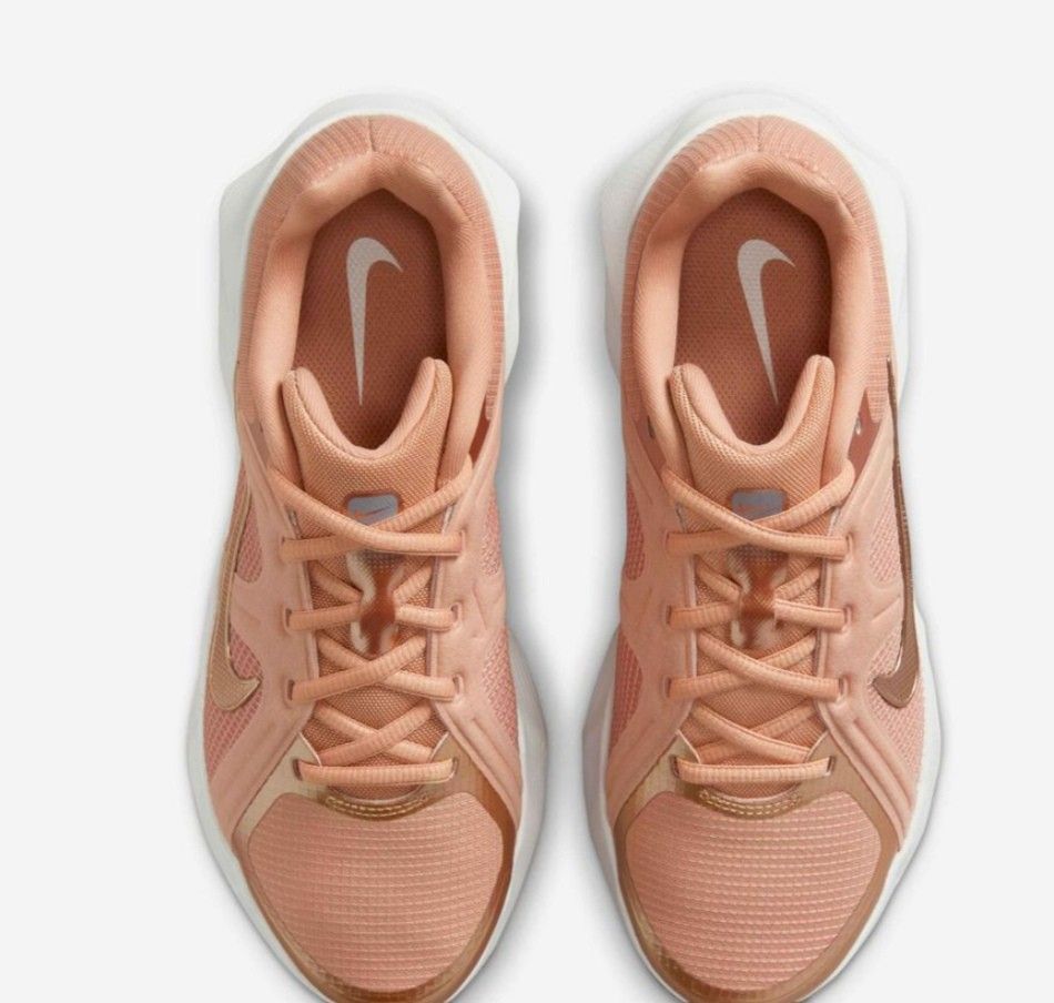 Nike Rose Gold Athletic Sneakers (Category: Sneakers) located in San Jose del Monte. Submitted by Skin_Care2022 (Listing ID 1466798700, Image 3). Description: - Brand/Model: Nike Sneakers - Colorway: Rose gold with metallic gold swoosh and branding - Design: Mesh panels and metallic overlays - Sole: White cushioned midsole with brown patterned rubber outsole - Condition: Clean uppers and pristine soles, ready to wear NEVER NASUOT, BRAND NEW!!! SI
