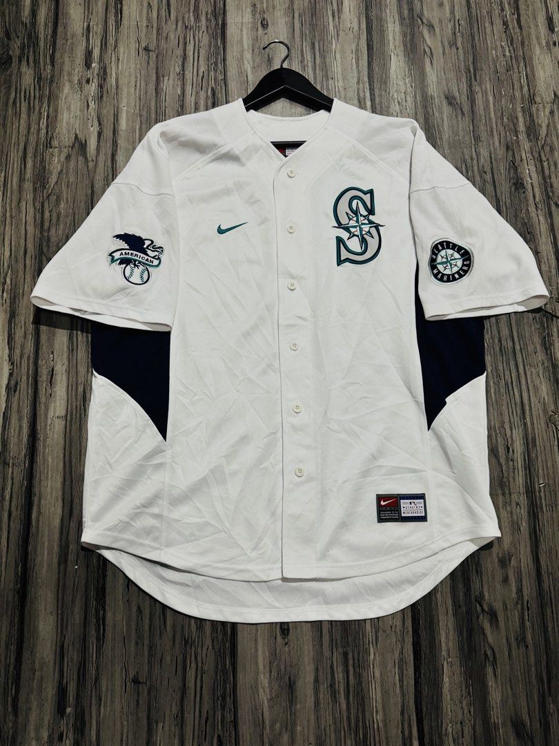 Nike Seattle Mariners Baseball Jersey White (Category: Activewear) located in Quezon City. Submitted by lucky_wisefish.2ca7d6 (Listing ID 1466965654, Image 1). Description: - Brand: Nike (Official MLB Merchandise) - Team: Seattle Mariners - Color: White with teal and navy accents - Features: Button-down front, Nike swoosh embroidery, American League & Mariners compass sleeve patches - Perfect for game days or casual wear - Loc: Philippines (Shipp