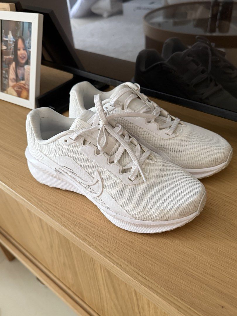 Nike White Running Sneakers (Category: Sneakers) located in Manila. Submitted by ania_g (Listing ID 1466866568, Image 1). Description: - Brand: Nike - Type: White running shoes / daily trainers - Material: Breathable mesh upper with textured swoosh logo - Sole: Cushioned white foam with textured tread - Condition: Clean white fabric, minimal wear on bottom tread - Fit: Standard fit, classic lace-up front - Best for: Gym sessions or everyday erran
