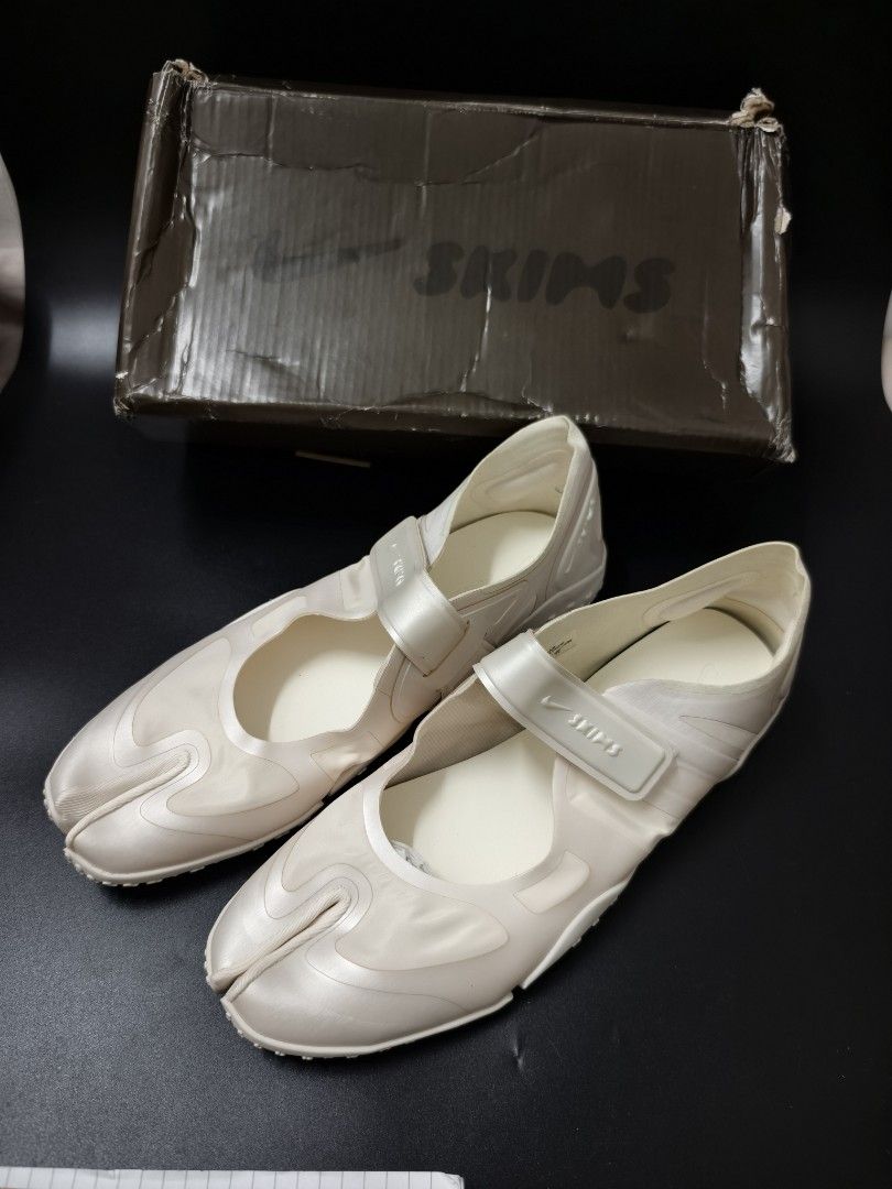 Nike x Skims Split-Toe Mary Jane Sneakers (Category: Sneakers) located in Angeles City. Submitted by measaliman02351 (Listing ID 1466967777, Image 1). Description: - Brand: Nike x Skims Collaboration - Style: Split-toe / Tabi Mary Jane sneakers - Color: Cream white - Features: Adjustable velcro strap with co-branded detailing, textured rubber outsole - Condition: Shoes are clean and unworn; size details on inner collar - Packaging: Original co-br
