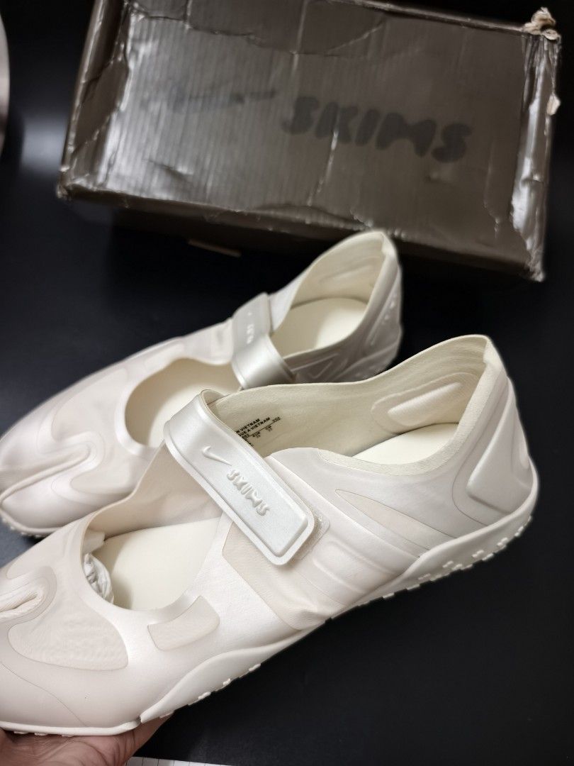 Nike x Skims Split-Toe Mary Jane Sneakers (Category: Sneakers) located in Angeles City. Submitted by measaliman02351 (Listing ID 1466967777, Image 3). Description: - Brand: Nike x Skims Collaboration - Style: Split-toe / Tabi Mary Jane sneakers - Color: Cream white - Features: Adjustable velcro strap with co-branded detailing, textured rubber outsole - Condition: Shoes are clean and unworn; size details on inner collar - Packaging: Original co-br