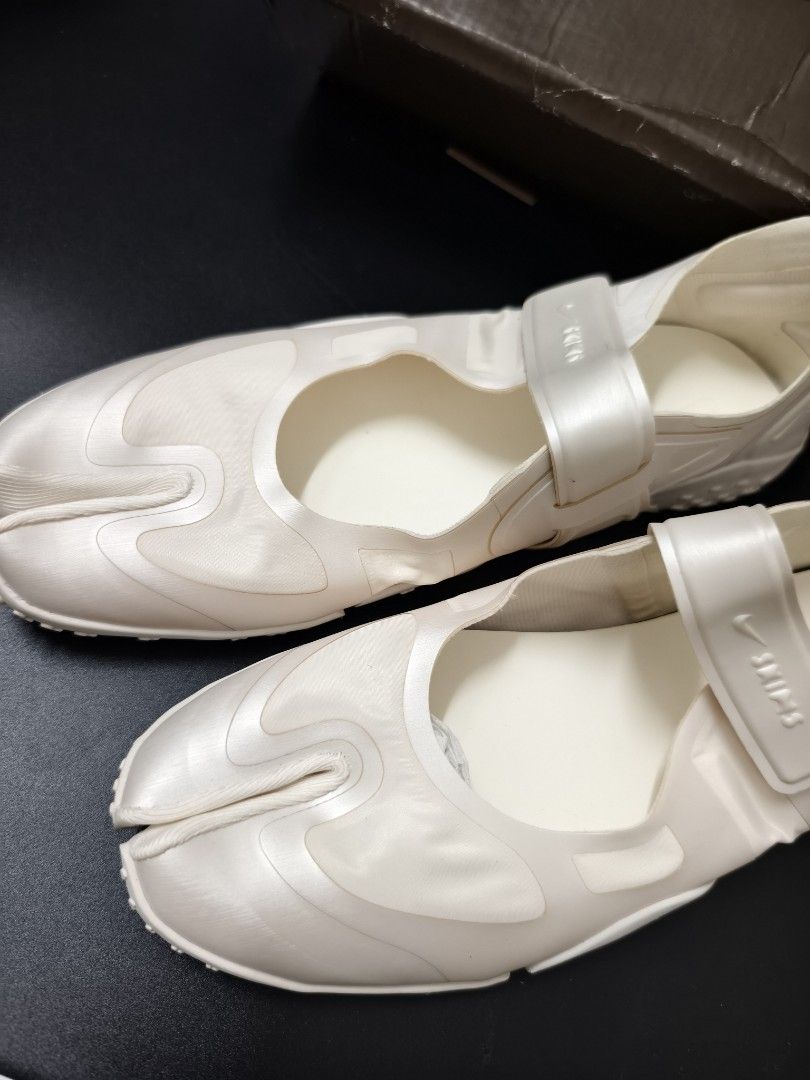 Nike x Skims Split-Toe Mary Jane Sneakers (Category: Sneakers) located in Angeles City. Submitted by measaliman02351 (Listing ID 1466967777, Image 2). Description: - Brand: Nike x Skims Collaboration - Style: Split-toe / Tabi Mary Jane sneakers - Color: Cream white - Features: Adjustable velcro strap with co-branded detailing, textured rubber outsole - Condition: Shoes are clean and unworn; size details on inner collar - Packaging: Original co-br