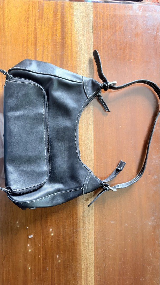 Nine west Black shoulder bag with front zip pocket (Category: Shoulder Bags) located in Manila. Submitted by serraphimav (Listing ID 1466778957, Image 2). Description: - Color & Style: Black shoulder bag with stylish white contrast stitching - Storage: Front flap pocket with zipper closure and secure zip-top main compartment - Design: Adjustable strap with trendy buckle details on both sides - Size: Compact, perfect for everyday use - Condition: 