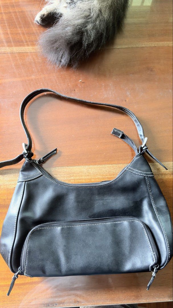 Nine west Black shoulder bag with front zip pocket (Category: Shoulder Bags) located in Manila. Submitted by serraphimav (Listing ID 1466778957, Image 1). Description: - Color & Style: Black shoulder bag with stylish white contrast stitching - Storage: Front flap pocket with zipper closure and secure zip-top main compartment - Design: Adjustable strap with trendy buckle details on both sides - Size: Compact, perfect for everyday use - Condition: 