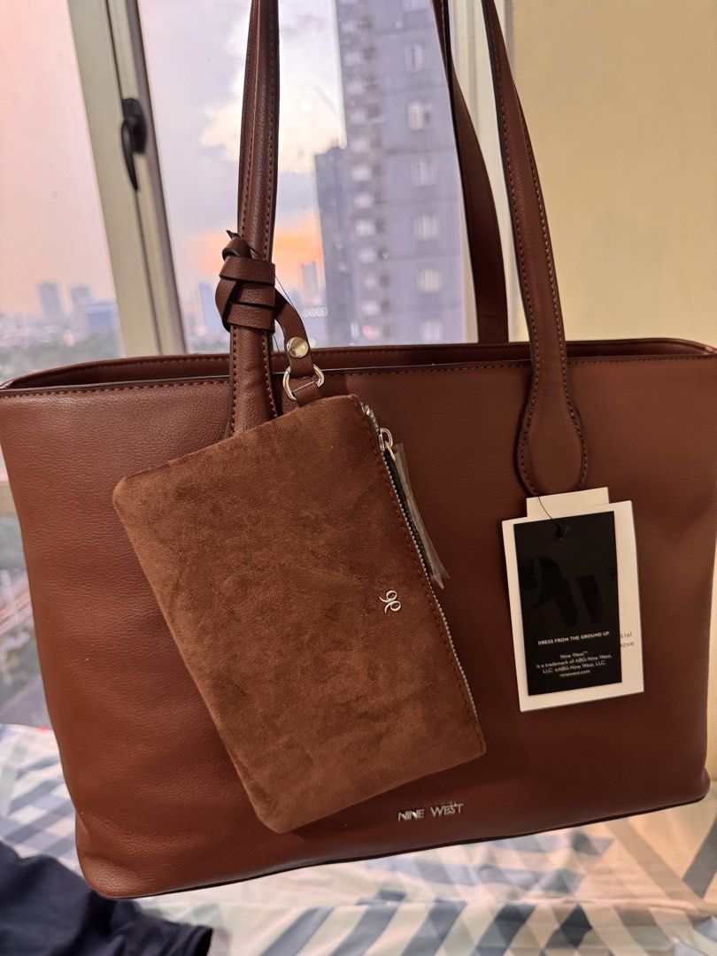 Nine West Brown Tote Bag with Pouch (Category: Tote Bags) located in Quezon City. Submitted by xtywop (Listing ID 1466844467, Image 2). Description: - Brand: Nine West - Color: Rich brown - Condition: Brand new with original store tags attached - Includes: Matching zippered suede pouch attached to the strap - Hardware: Silver-tone with subtle front branding - Interior: Multiple compartments with a convenient central zip divider - Extras: Stuffed 