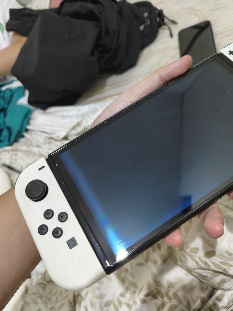 Nintendo Switch OLED Model White with 3 Games (Category: Nintendo) located in Quezon City. Submitted by oddearth-46c4c8 (Listing ID 1466874344, Image 1). Description: - Nintendo Switch OLED Console (White) in excellent, fully working condition - Crisp screen that powers on normally - Original dock included for TV gaming - Includes 3 physical game cartridges: Pokemon Legends Arceus, Monster Hunter Generations Ultimate, and Lego Marvel Super Heroes