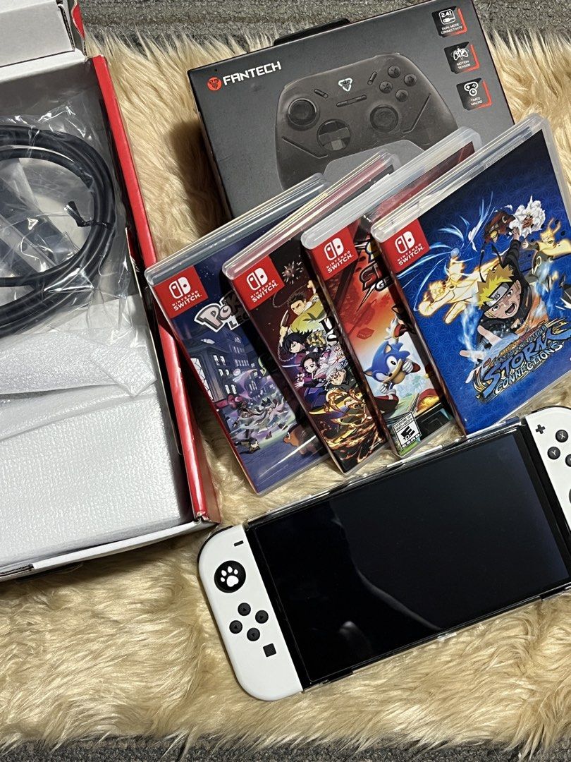 Nintendo Switch OLED White Console with Games and Controller (Category: Nintendo) located in Manila. Submitted by yurimahboy (Listing ID 1466778867, Image 1). Description: - Nintendo Switch OLED White Console - 4 Physical Games: Pokémon Legends, Demon Slayer, Sonic, and Naruto Shippuden - Fantech Shooter III multi-platform gamepad controller - Complete with original box, console packaging, and HDMI cable - All-in-one ready-to-play gaming bundle.