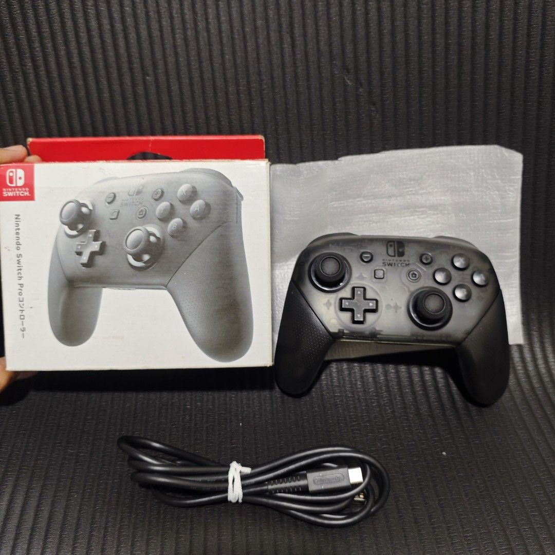 Nintendo Switch Pro Controller (Category: Controllers) located in Quezon City. Submitted by shopme_gadget30 (Listing ID 1466926643, Image 3). Description: kindly read the details first for sale fixed price Good Condition tested and working no drifting all buttons working with box and charging cord compatible to Nintendo switch v1/v2/ or oled ,pc android Original with bag and charging cord qc area meet up: sm north shipping fee must shoulder by th