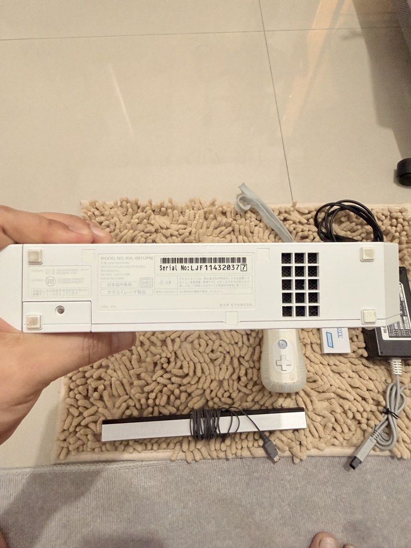 Nintendo Wii Console RVL-001 with Controller and Accessories (Category: Nintendo) located in Quezon City. Submitted by ShopNShip (Listing ID 1466880335, Image 2). Description: Nintendo Wii white console, model RVL-001. Serial number LJF114320377. Includes one remote controller with silicone sleeve and wrist strap. Sensor bar, power supply unit, and Wii2HDMI adapter included. All cords bundled together neatly. Ready for setup and gaming..
